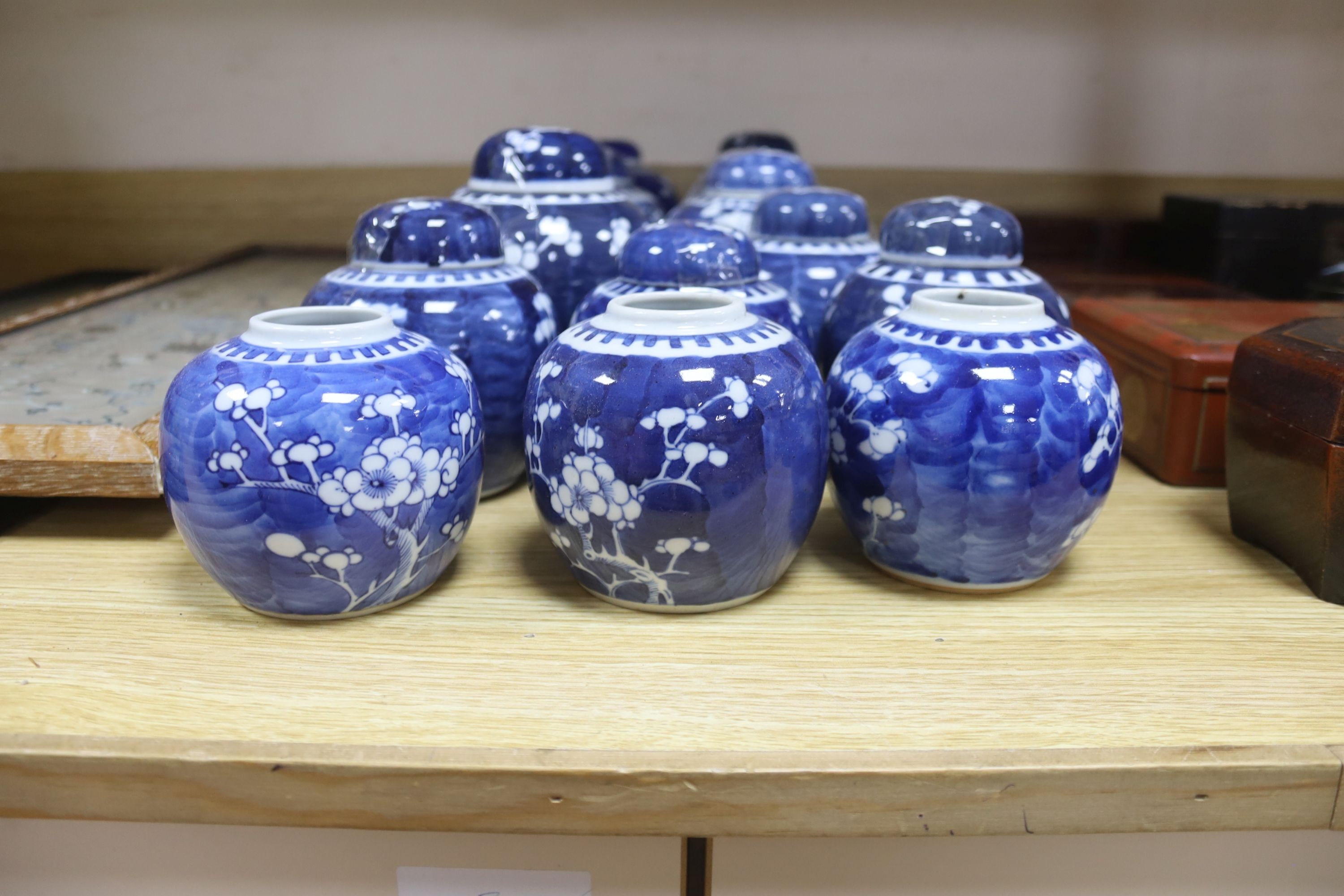 Fourteen Chinese blue and white prunus jars some with covers
